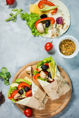 Healthy vegan lunch snack. Tortilla wraps with mushrooms, fresh vegetables and Ingredients on...