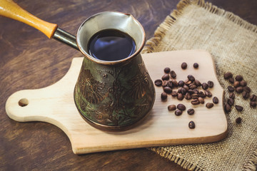 Fototapeta na wymiar Vintage сezve. coffee beans. wooden background.
