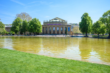 Fototapeta na wymiar Stuttgart State Theatre Opera building and fountain in Eckensee lake, Germany