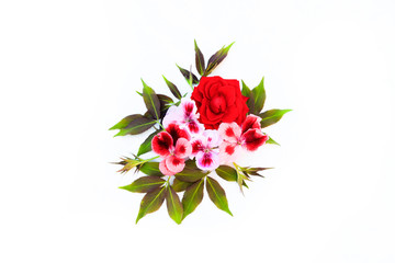 Beautiful flowers composition on white and blue old concrete background as a sky with clouds with spring flowers and leaves. Easter or summer concept with copy spase. Flat lay, top view.