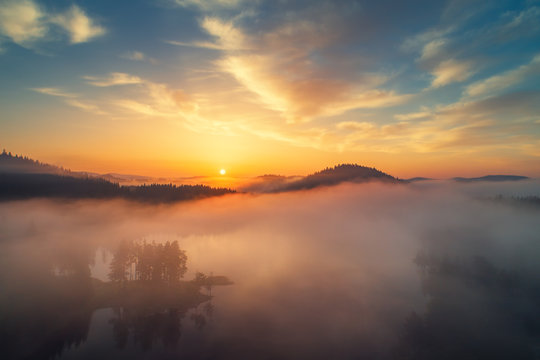 Aerial view of morning fog on the lake, sunrise shot