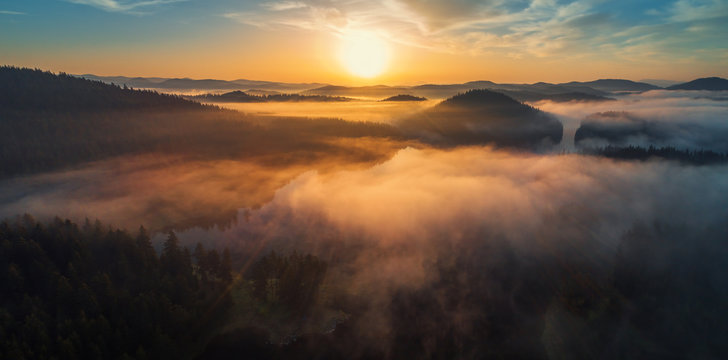 Fototapeta Aerial view of morning fog on the lake, sunrise shot