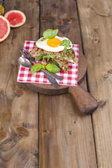 Sandwich of corn bread with egg and ham for breakfast. A healthy and delicious breakfast. Wooden background. Fitness food, toast.