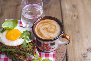 Sandwich of corn bread with egg and ham for breakfast. A healthy and delicious breakfast and coffee. Wooden background. Fitness food