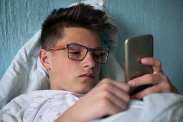 sad teenager uses a mobile phone