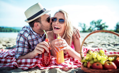 Beautiful young couple having fun on the beach. Lifestyle, love, dating, vacation concept