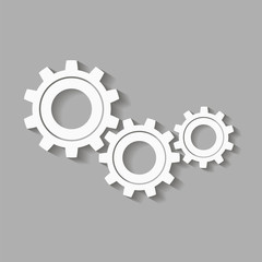 Mechanical gears with a shadow. Vector icon