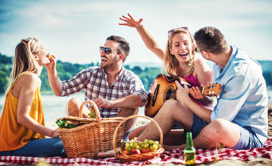 Group of friends having fun on the beach. Lifestyle, vacation concept