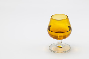 Glass with alcohol and white background