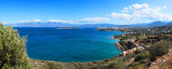 Panoramic high point view at sunset of the picturesque gulf of Mirambello, with the island of Agioi Pantes and the town of Agios Nikolaos, Crete, Greece