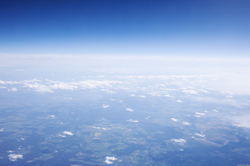Naklejka na ściany i meble Beautiful view through airplane window. Happy journey above the sky.