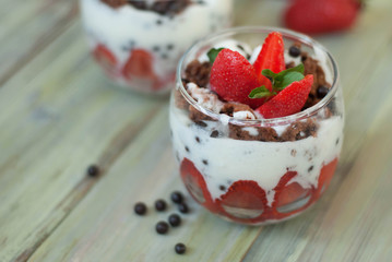 Strawberry Cake in Glass with White Crea mans Strawberry. Homemade summer dessert on white rustic table.