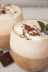 Iced Mocha Coffee with Whip Cream, Summer Drinking times. Coffee Beans. rustic textured Wooden Background. Mint Leaves