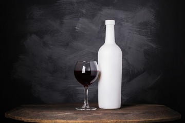 Wine bottle and glass on wooden background