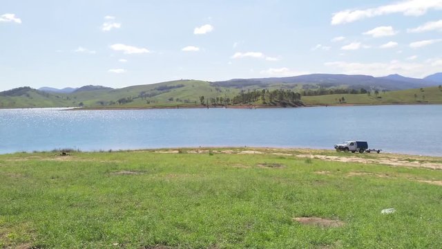 Australian lakes, UHD pan view of Lake St Clair and surrounding mountain, nature landscapes, on a sunny summer day, in Sydney, Australia