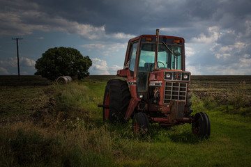 Old red tractor in farmland, Warwick, Australia