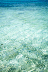 Bright, clear and calm turquoise waters over a Caribbean reef surrounding a paradise island