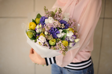 Girl holding a beautiful bouquet of tender spring flowers