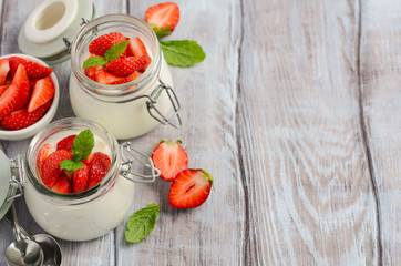 Homemade natural yogurt with strawberries and mint, selective focus, copy space