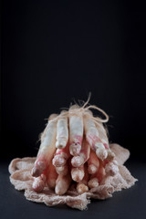 bunch of white asparagus decorated on a dark slate plate, can be used as background