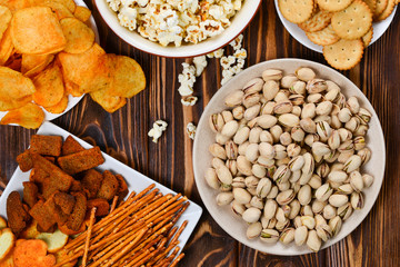 Snacks on a wooden background. Space for text or design.