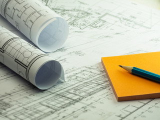 Architectural plan, technical project drawing with orange sticky notes and pencil. Architecture planning of design on paper, construction plan