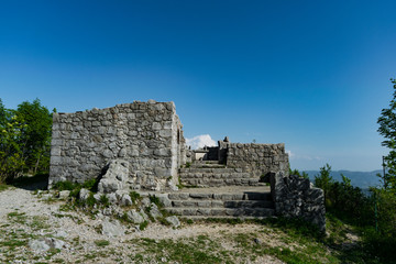 Fototapeta na wymiar Rovine della antica chiesa, ancora consacrata, di San Valentino, di epoca medievale, sul monte Sabotin