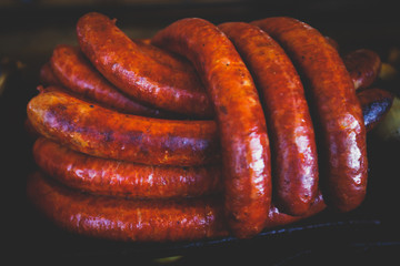 Fried baked sausages, hot dog on street food outdoor market stall in Budapest, Hungary, european street food.