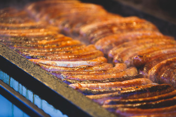 Fried baked sausages, hot dog on street food outdoor market stall in Budapest, Hungary, european street food.