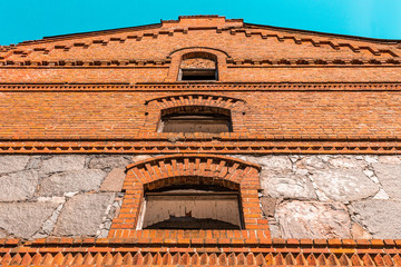 Ruined abandoned building, red brick facade