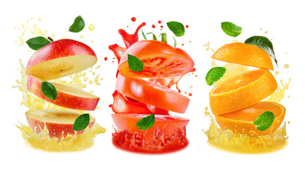 Variation of flying sliced Apple, orange and tomato with juice splashes and flying leaves
