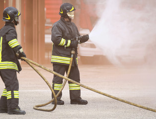 two firemen with a mask shut down a fire