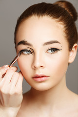 Glamourous closeup female portrait. Fashion elegance eyeliner makeup on model eyes. Cosmetics and make-up