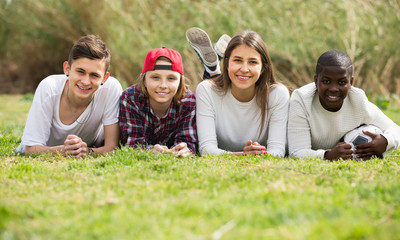 Two girls and two boys posing in spring park