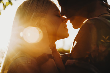 Close up portrait of a beautiful young couple waiting to kiss in their traveling time against...