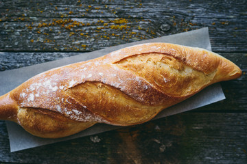 Delicious homemade organic bread on wooden table top view 
