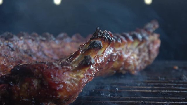 Grilling a rack of Baby Back Ribs on the Barbecue with smoke
