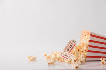 Drink popcorn and movie tickets on white background front detail © Davizro Photography