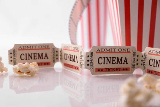 Cinema ticket and popcorn white background detail
