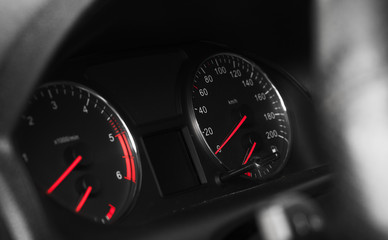 Car dashboard with speedometer on black