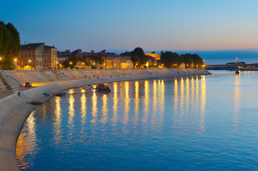 Obraz premium People walking embankment Arles, France
