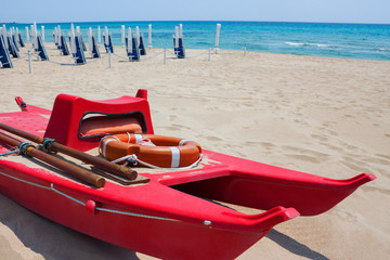 Rescue boat with lifebuoy on the shore against of beach and sea