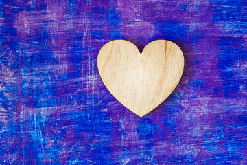 Wooden heart on abstract lilac painted wooden wall witn strokes