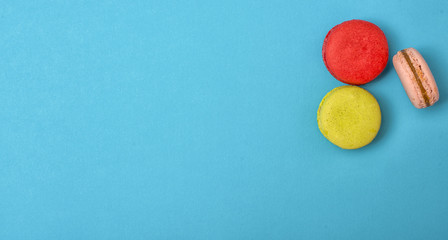 Cake macaroon on blue background , colorful almond cookies, top view.	