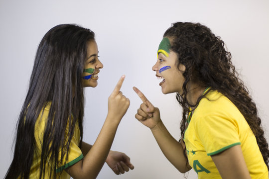 Brazilian girls discussing or betting. They point the finger at each other