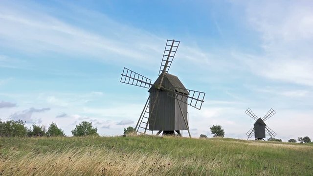 Timelapse of Old Wooden Windmills on Beautiful Landscape. 4K Ultra HD
