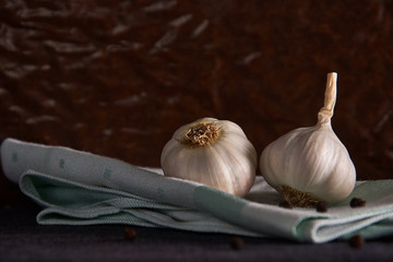 garlic, black pepper and bay leaf on a napkin