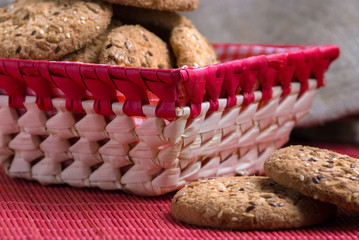 Savory cookies sprinkled with sesame seeds, sunflower on table and burlap background
