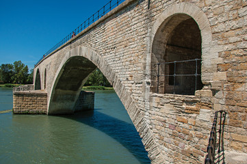 View of the arcs of the Pont d'Avignon (bridge) under a sunny blue sky, city of Avignon. Located in the Vaucluse department, Provence-Alpes-Côte d'Azur region, southeastern France