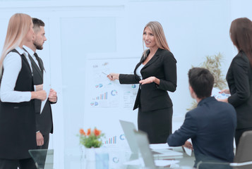 business woman doing a presentation to his business team.